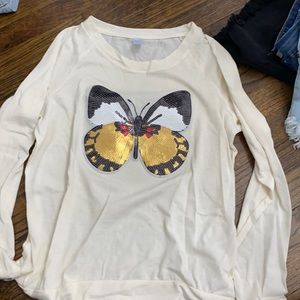 sparkle butterfly on a beige long sleeve shirt